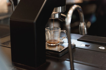 Barista making a espresso with a coffee machine.