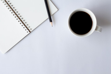 Creative flat lay of coffee with notebook on white desk with copy space.minimal.