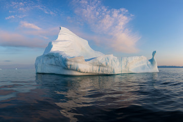 Iceberg at sunset. Nature and landscapes of Greenland. Disko bay. West Greenland. Summer Midnight...