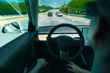 Person in a self driving autonomous car with autopilot