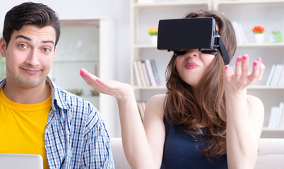 Young family playing games with virtual reality glasses