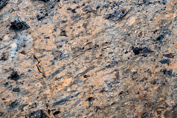 The texture of the stone overgrown with moss. Background image of a boulder