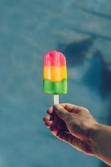 ice cream in hand on green background