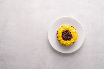 Beautiful sunflower decorated chocolate cupcake on white background