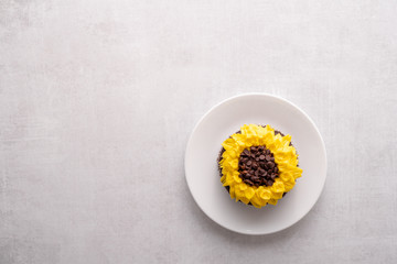Beautiful sunflower decorated chocolate cupcake on white background