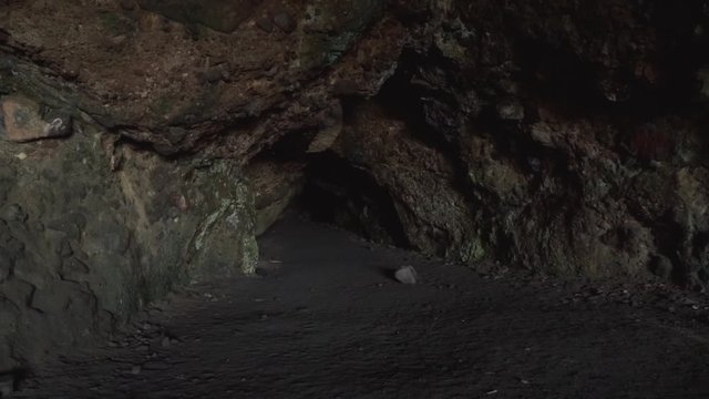 Entrace of dark lava tunnel cave in New Zealand