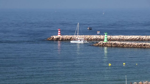 Villamoura harbour entrance  in the Agarve Portugal with boats and and light houses on a calm sunny morning