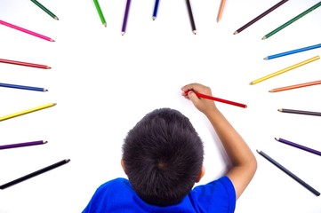 A boy creating art With a coloring pencil With many colors On a white background.