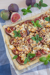 home made tart with figs and cheese on a table