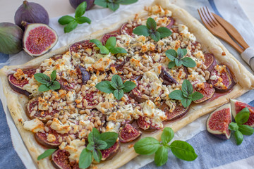 home made tart with figs and cheese on a table