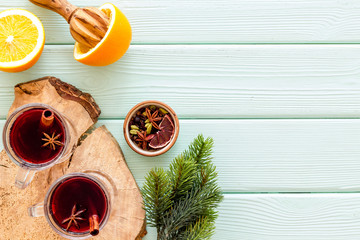 Mulled wine and fir branches frame on green wooden background top view copy space