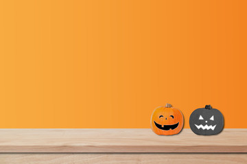 Halloween holiday concept;  pumpkin decor on wooden table with orange background