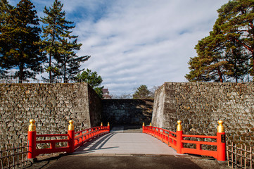 Aizu Wakamatsu Tsuruga Castle Rokabashi red bridge under winter blue sky. Fukushima - Japan