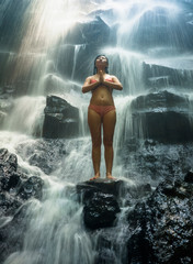 Obraz premium natural portrait of young beautiful and happy Asian Korean woman in bikini enjoying nature at tropical paradise waterfall with magical feeling in soul inspiration