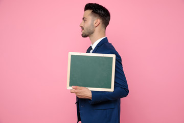 side view of smart casual man holding an empty board