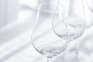 Empty  glasses  of wine on the white tablecloth. Abstract  background.