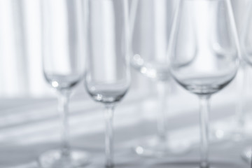 Several glasses for different kind of wine on the white tablecloth.