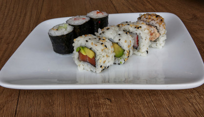 Sushi set: Uramaki sushi with rice. Seaweed hosomaki sushi. Asian traditional food. 