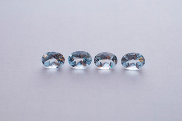 Natural faceted blue aquamarine on the white background