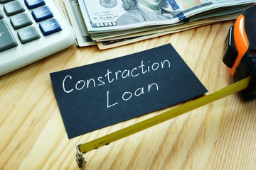 Construction loan concept. Measuring tape and money.