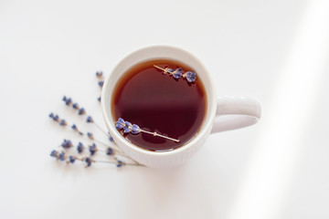white Cup of tea with lavender. lavender sprigs.