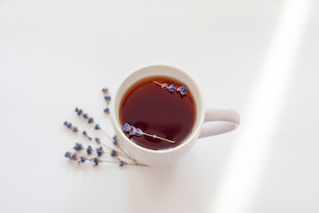 white Cup of tea with lavender. lavender sprigs.