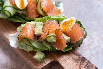 Lettuce wrapped smoked salmon tacos with fresh cucumber, avocado and quail eggs