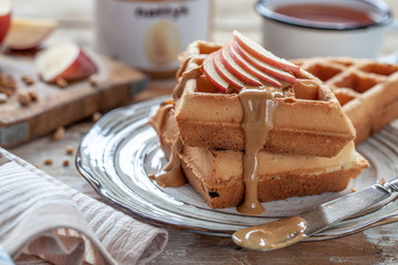 Waffles with peanut butter and red apple