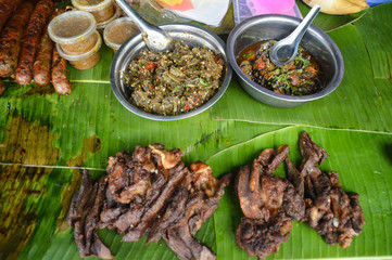 Stall selling Lao sausage or sou oa, beef jerky or jeow bong and minced meat salad called larb, authentic local food reflecting the heritage and culture of Laos