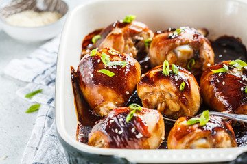 Oven-baked teriyaki chicken with green onions and sesame seeds.