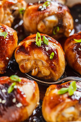 Oven-baked teriyaki chicken with green onions and sesame seeds.