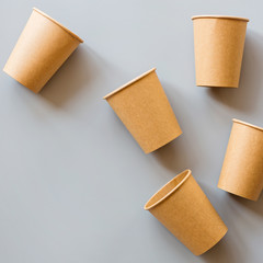eco natural paper coffee cups flat lay on gray background. sustainable lifestyle concept. zero waste, plastic free items. stop plastic pollution. Top view, overhead, mockup, template