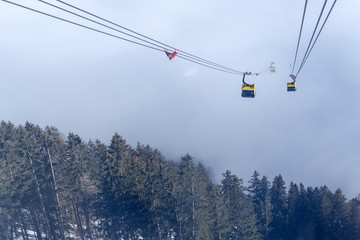A river of white fog in the mountains and a ski lift in the foreground. Selective focus in the background.Alpine Alps mountain landscape at Tirol, Top of Europe
