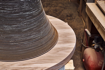 Joinery. Creative round shape coffee table made of mdf and natural wood