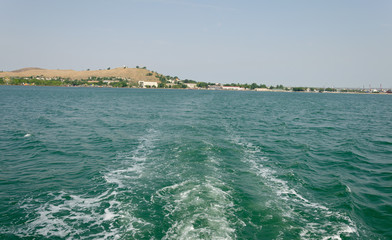 Trail on the water for a pleasure boat in the summer at sea.