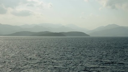 Rocky headland and scenic coastline of Corfu. Landscape of the Mediterranean sea in Greece at sunset. 4K