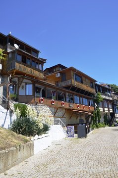 Nesabar, Bulgaria, 06/13/2017.  Wooden houses on street in Nesabar near black sea, blue  sky