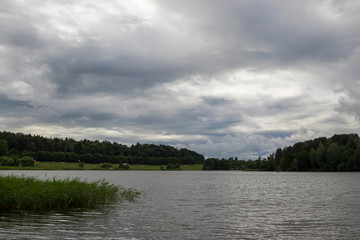 Storm clouds over lake, dramatic sky.