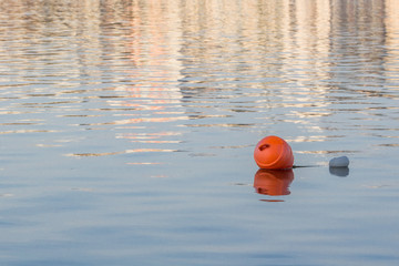 Pointer to the water. Buoy on a lake or river. Warning label. Attention to danger. Route and limiter at water competitions. Depth of a body of water, sea or ocean. Safety on the water.