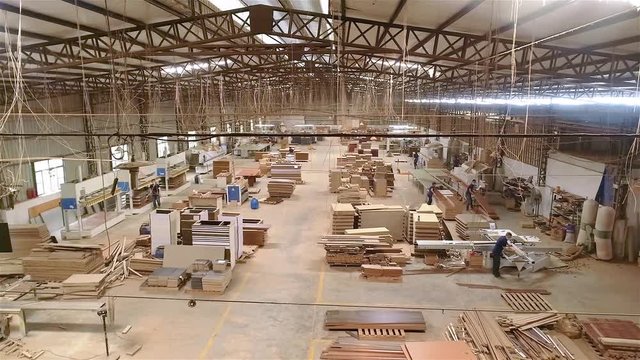 Panoramic view of a large furniture factory. People work in a furniture factory. Large furniture manufacturing plant