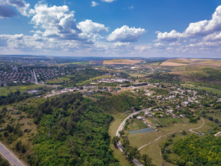 Aerial view over a small village and agricultural fields