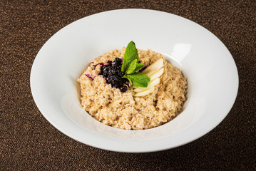 Bowl of oatmeal porridge with berry sauce