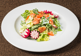 salad with fresh vegetables on the white plate