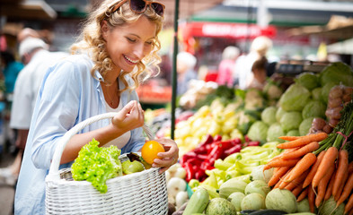 Woman holding a basket with healthy organic vegetables