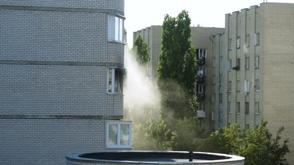 Clouds of grey smoke coming from the window of a burning apartment. 4K