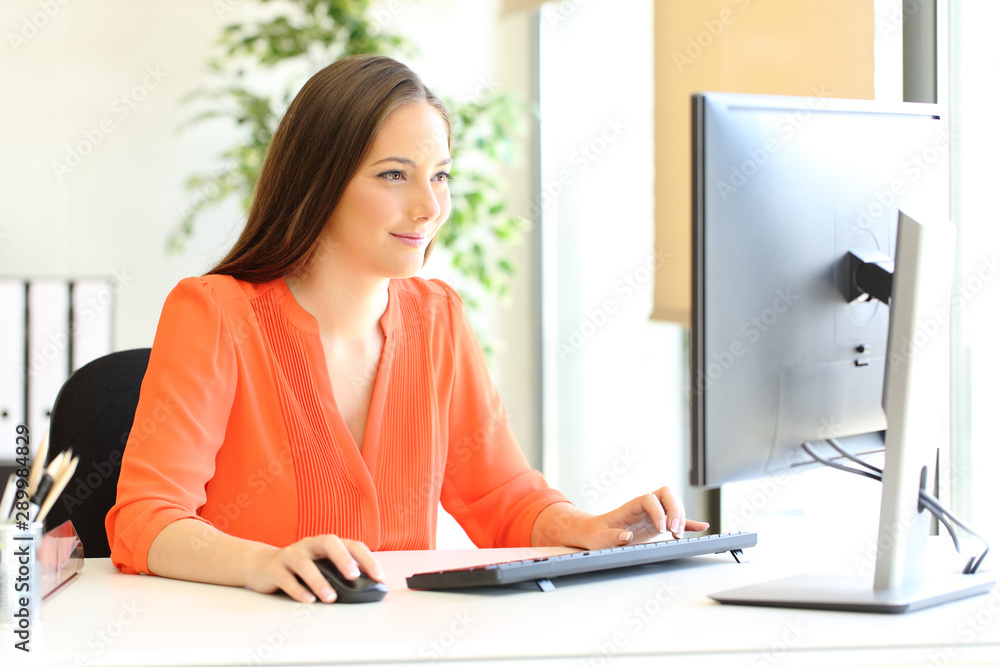 Sticker entrepreneur in orange working with desktop computer