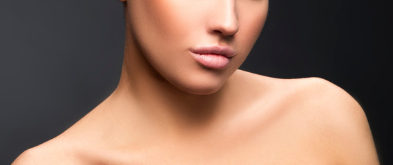 Lips, shouldrs, beauty part of face of young woman, perfect skin. Gray background