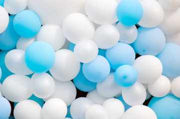 Many colorful white and blue balloons decorated wall, balloons background, closeup