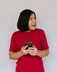 Surprised happy woman with smartphone on white background