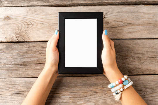 Young Woman Holding Empty Picture Frame With Copyspace. Mockup
